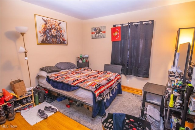 bedroom with hardwood / wood-style floors