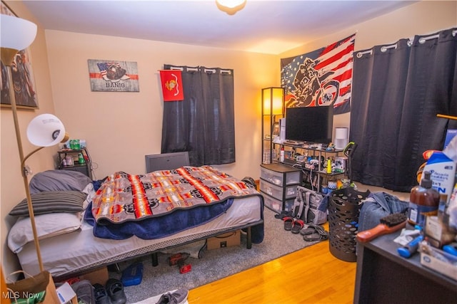 bedroom with wood-type flooring