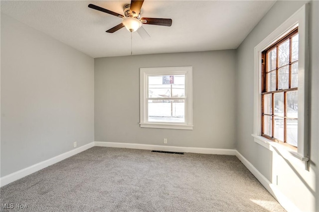 spare room featuring carpet flooring and ceiling fan