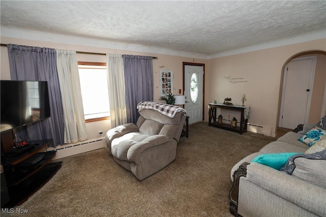 carpeted living room featuring a baseboard radiator and a textured ceiling