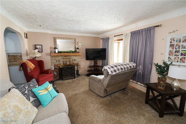 living room featuring a fireplace, a baseboard radiator, a textured ceiling, and carpet flooring