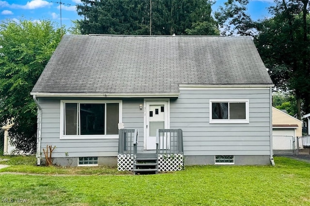 rear view of house with a lawn