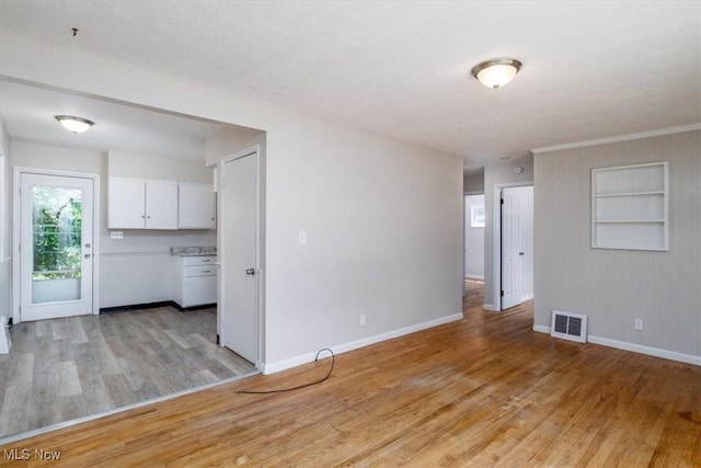 interior space with light hardwood / wood-style floors and built in shelves