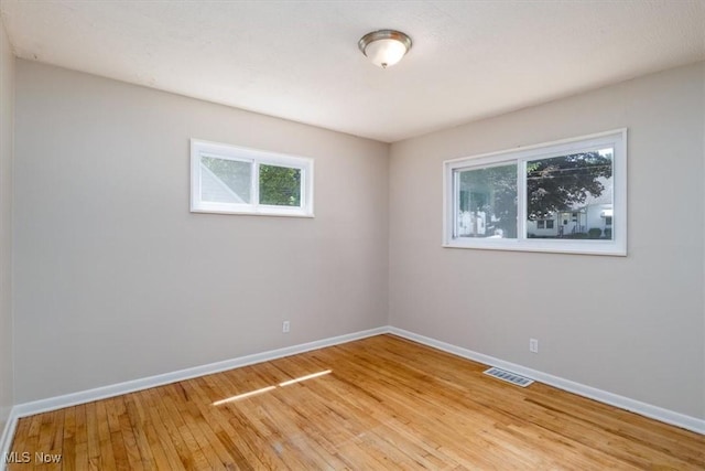 unfurnished room featuring hardwood / wood-style floors