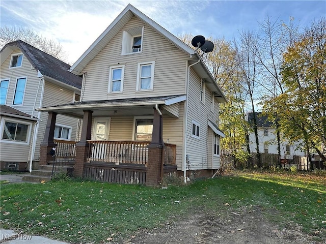 view of front of home featuring a front yard and covered porch