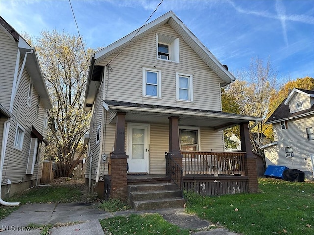 view of front of property with a porch and a front lawn