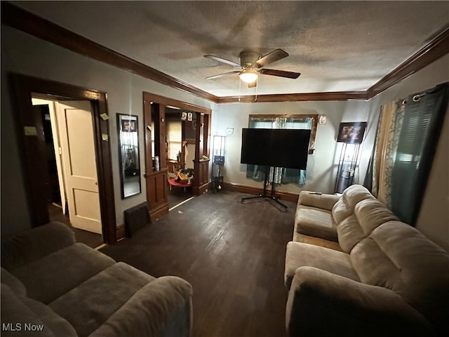 living room featuring ceiling fan, ornamental molding, dark hardwood / wood-style flooring, and a textured ceiling