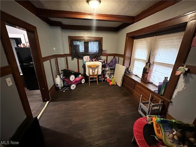 interior space with a textured ceiling and beamed ceiling