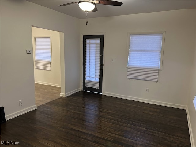 empty room featuring dark hardwood / wood-style floors and ceiling fan