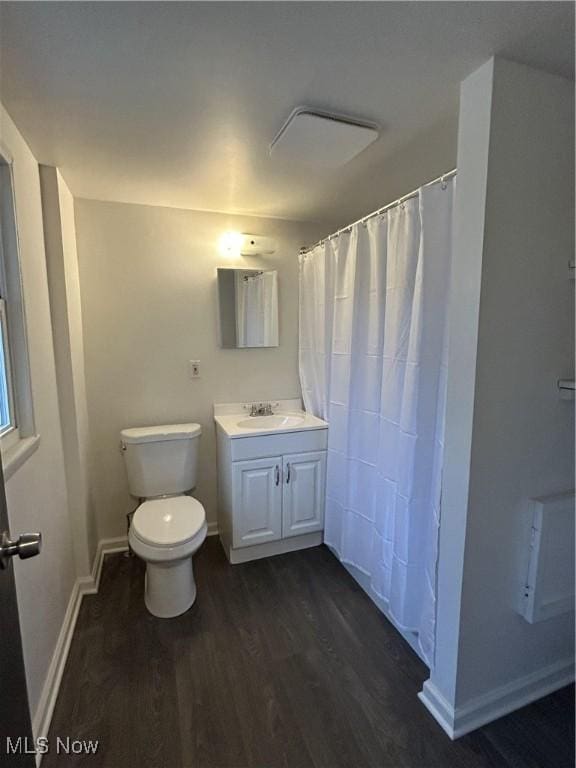 bathroom featuring vanity, hardwood / wood-style floors, and toilet