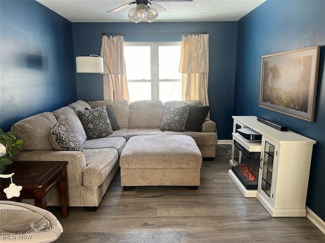 living room with dark hardwood / wood-style floors and ceiling fan