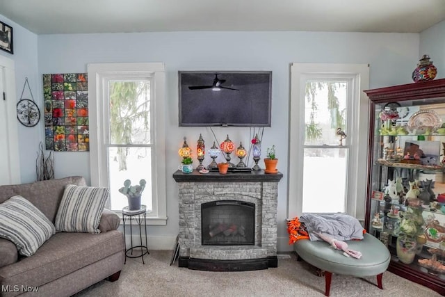 living room featuring a fireplace and carpet flooring