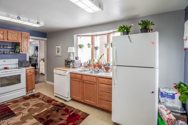 kitchen with light tile patterned flooring, sink, and white appliances