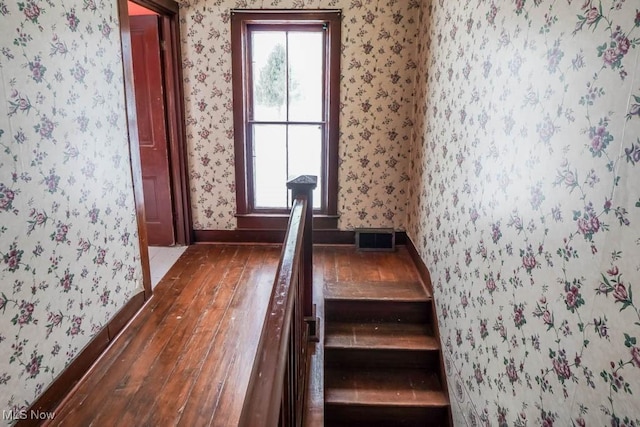 stairway featuring wood-type flooring