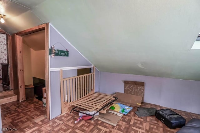 bonus room featuring parquet floors and vaulted ceiling