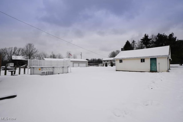 yard covered in snow with an outdoor structure