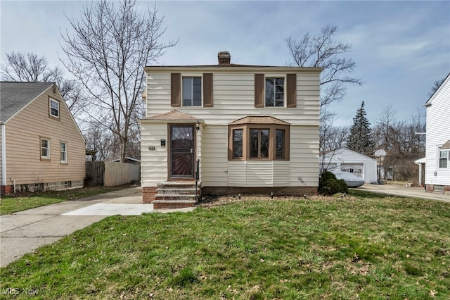 view of front property featuring a garage and a front yard