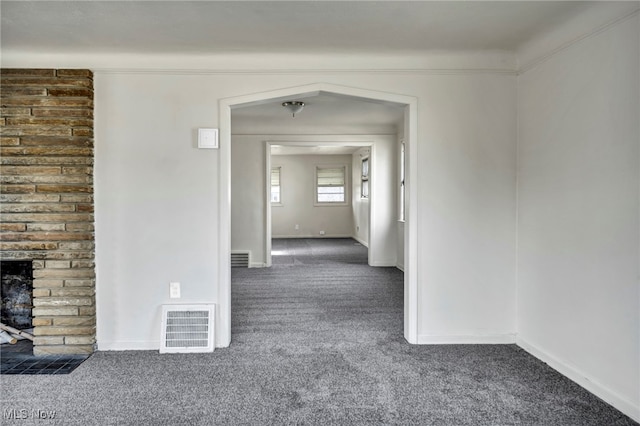 hallway featuring dark colored carpet