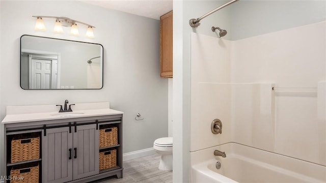 full bathroom featuring vanity, tub / shower combination, and toilet