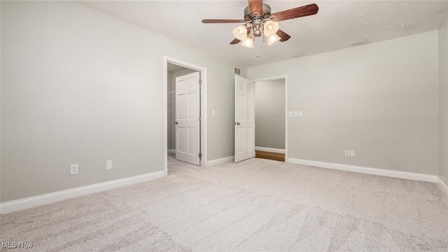 unfurnished bedroom featuring light colored carpet and ceiling fan