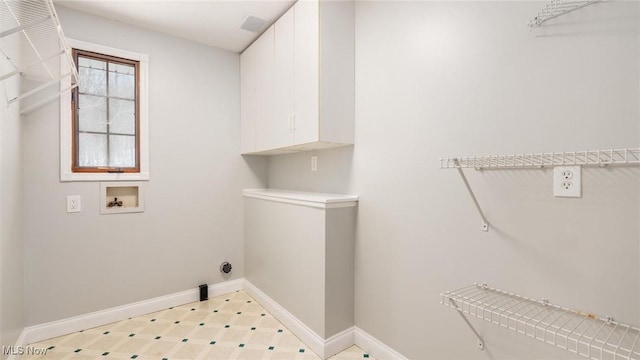 washroom with cabinets and hookup for a washing machine