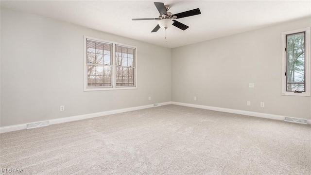 unfurnished room featuring ceiling fan and carpet flooring