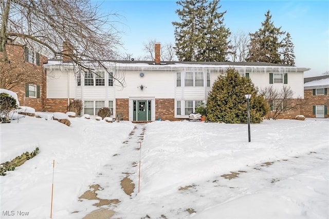 view of snow covered rear of property