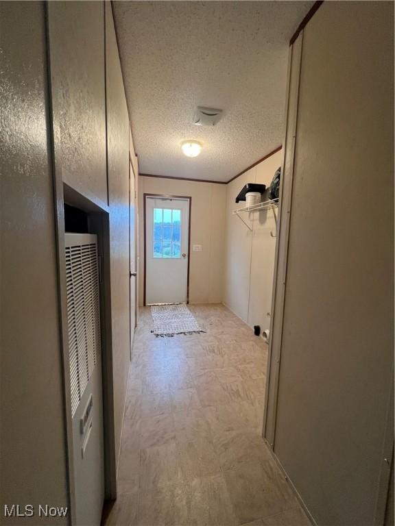 hallway featuring a textured ceiling