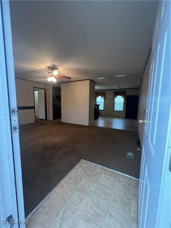 carpeted empty room featuring ceiling fan