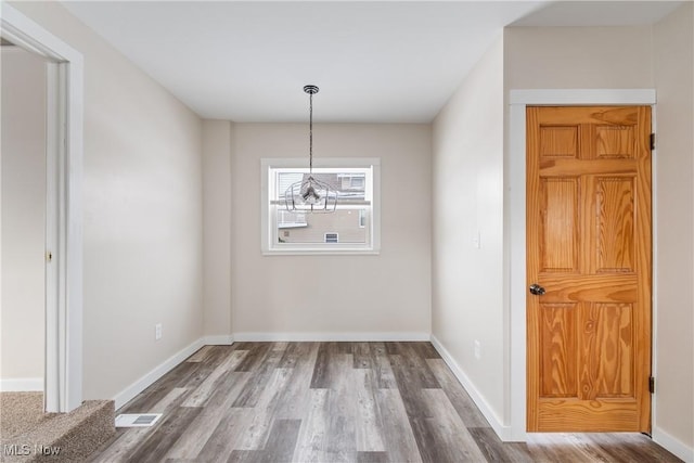 750 Florida Ave, Akron, OH 44314 - unfurnished dining area featuring baseboards, visible vents, and wood finished floors