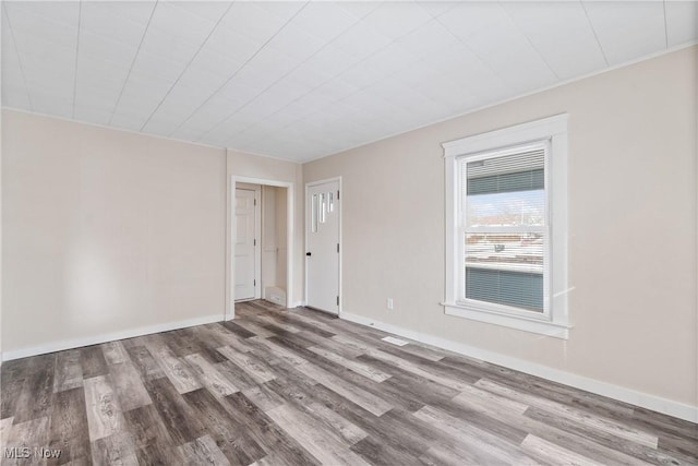 unfurnished room with wood-type flooring