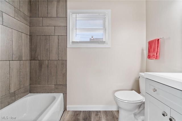 bathroom featuring vanity, wood-type flooring, and toilet