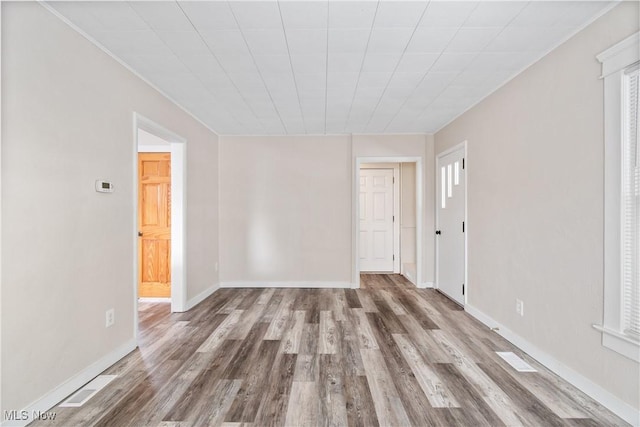 spare room with wood-type flooring