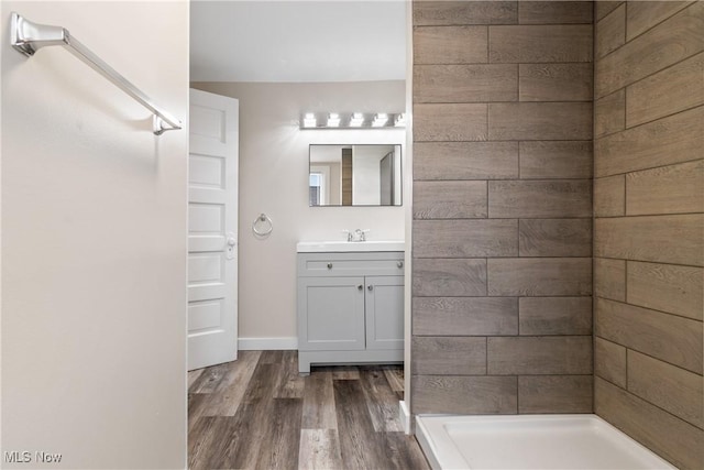 bathroom featuring vanity, hardwood / wood-style flooring, and a shower