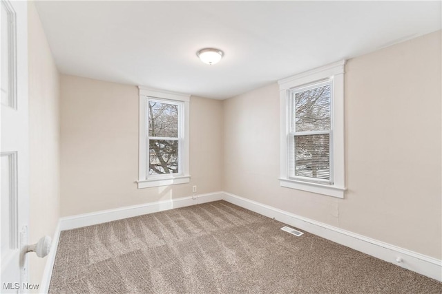 spare room featuring carpet flooring