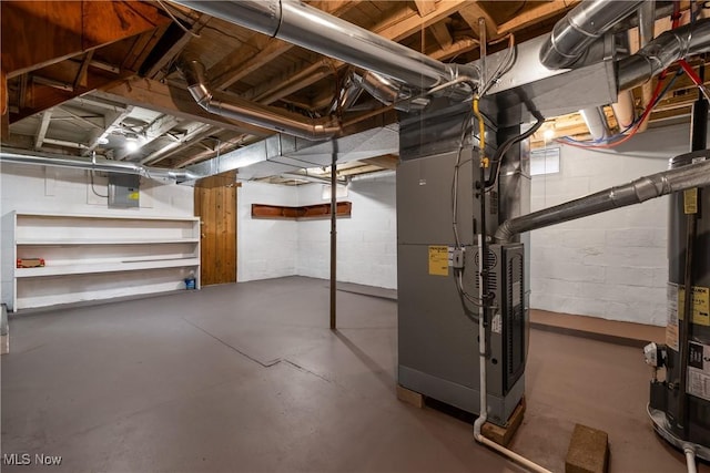 basement featuring electric panel and heating unit