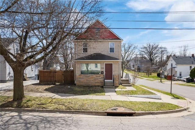 750 Florida Ave, Akron, OH 44314 - view of front of house featuring fence, stone siding, and a residential view