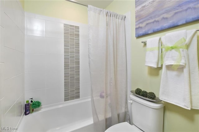 bathroom featuring toilet and shower / bath combo