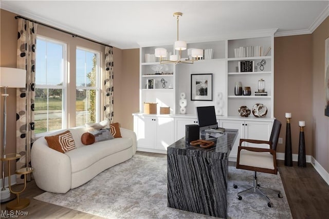 home office with ornamental molding, wood-type flooring, and a chandelier