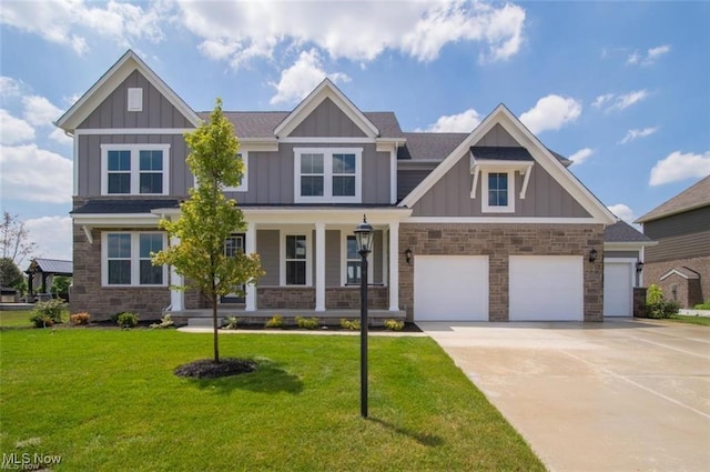 craftsman-style home featuring a porch, a garage, and a front yard