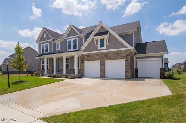 craftsman inspired home featuring a garage, a front lawn, and covered porch