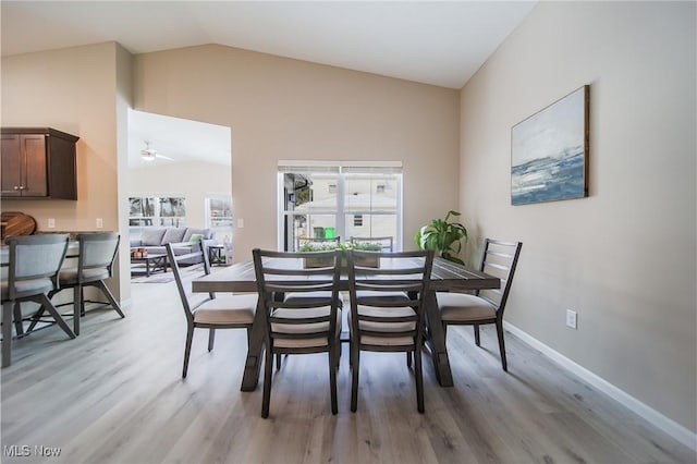 dining area with vaulted ceiling, light hardwood / wood-style floors, and ceiling fan