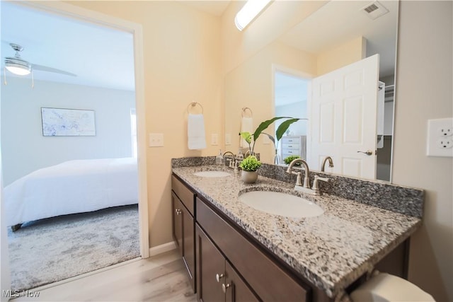 bathroom with vanity, hardwood / wood-style floors, and ceiling fan