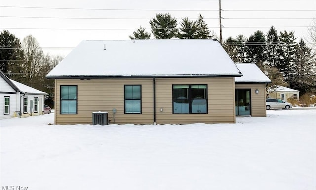 snow covered house with central AC