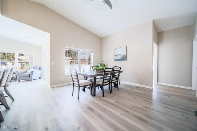 dining space featuring vaulted ceiling, ceiling fan, and light hardwood / wood-style floors