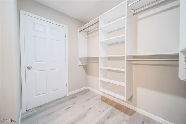 walk in closet featuring light hardwood / wood-style floors