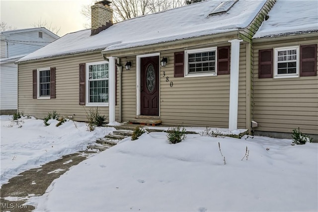 view of snow covered property entrance