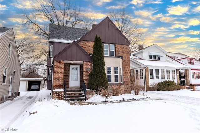 view of front of property featuring a garage and an outdoor structure