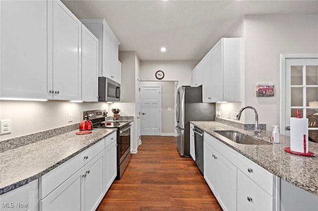 kitchen featuring stainless steel appliances, sink, white cabinets, and dark hardwood / wood-style floors