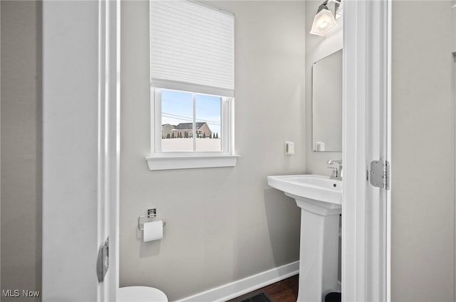 bathroom with sink and hardwood / wood-style flooring